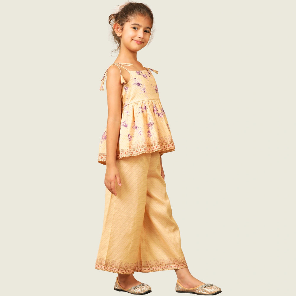 
                  
                    A radiant festive set crafted from soft chanderi fabric, Kanak features a delicate sleeveless peplum top adorned with pastel floral motifs and intricate lace edging. 
                  
                