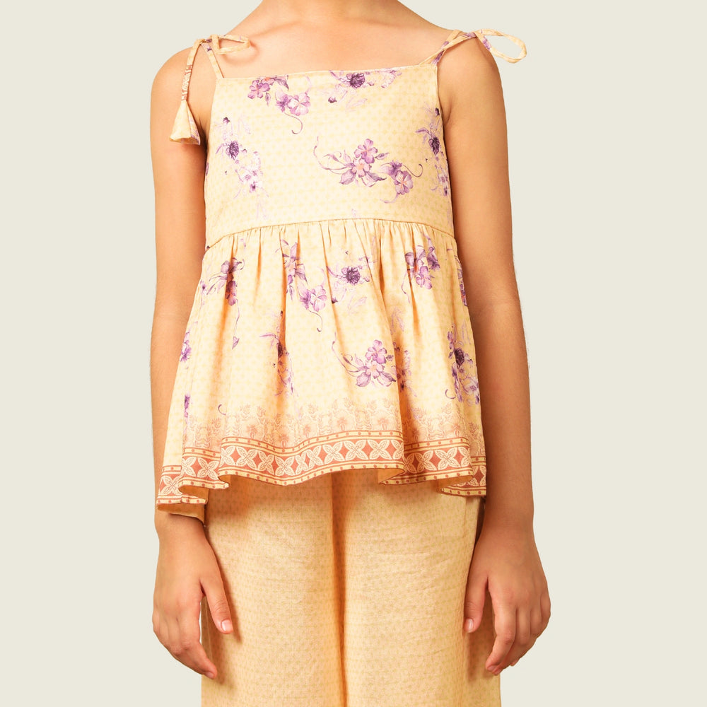 
                  
                    A radiant festive set crafted from soft chanderi fabric, Kanak features a delicate sleeveless peplum top adorned with pastel floral motifs and intricate lace edging. 
                  
                