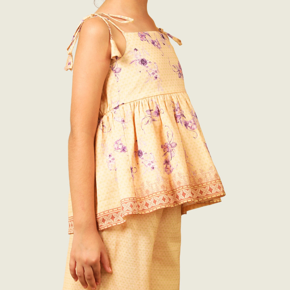 
                  
                    A radiant festive set crafted from soft chanderi fabric, Kanak features a delicate sleeveless peplum top adorned with pastel floral motifs and intricate lace edging. 
                  
                