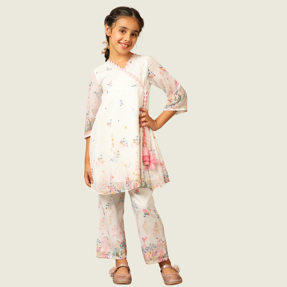 
                  
                     the Noor Kurti Set is a graceful ensemble perfect for dreamy celebrations. Set against a gentle white backdrop, the kurta features delicate multicolor floral prints scattered like wildflowers across the fabric. 
                  
                