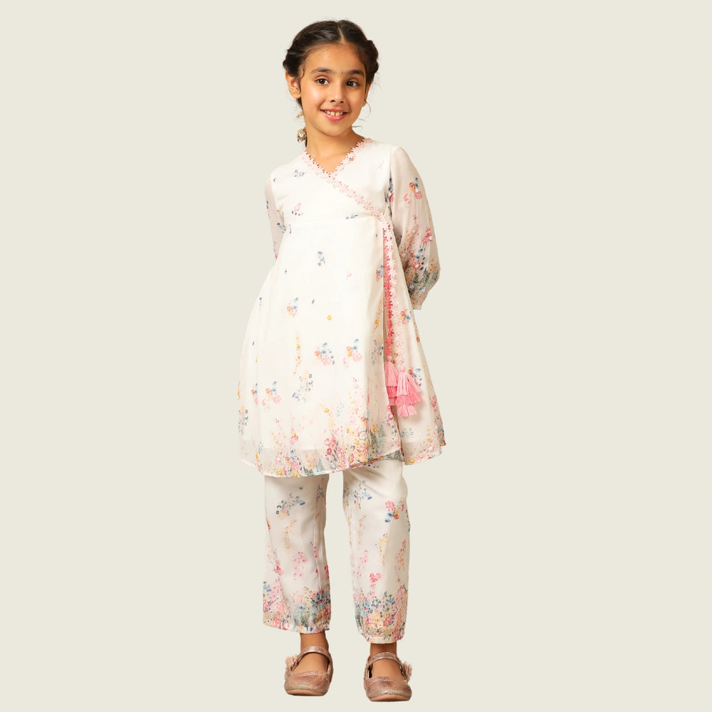 
                  
                     the Noor Kurti Set is a graceful ensemble perfect for dreamy celebrations. Set against a gentle white backdrop, the kurta features delicate multicolor floral prints scattered like wildflowers across the fabric. 
                  
                