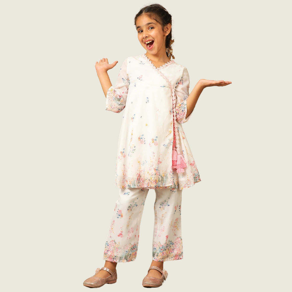 
                  
                     the Noor Kurti Set is a graceful ensemble perfect for dreamy celebrations. Set against a gentle white backdrop, the kurta features delicate multicolor floral prints scattered like wildflowers across the fabric. 
                  
                