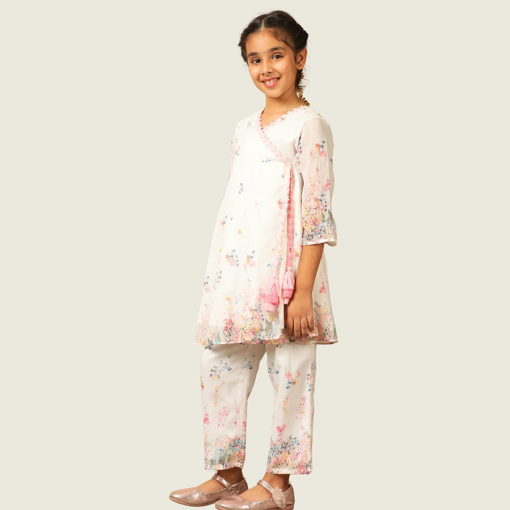 
                  
                     the Noor Kurti Set is a graceful ensemble perfect for dreamy celebrations. Set against a gentle white backdrop, the kurta features delicate multicolor floral prints scattered like wildflowers across the fabric. 
                  
                