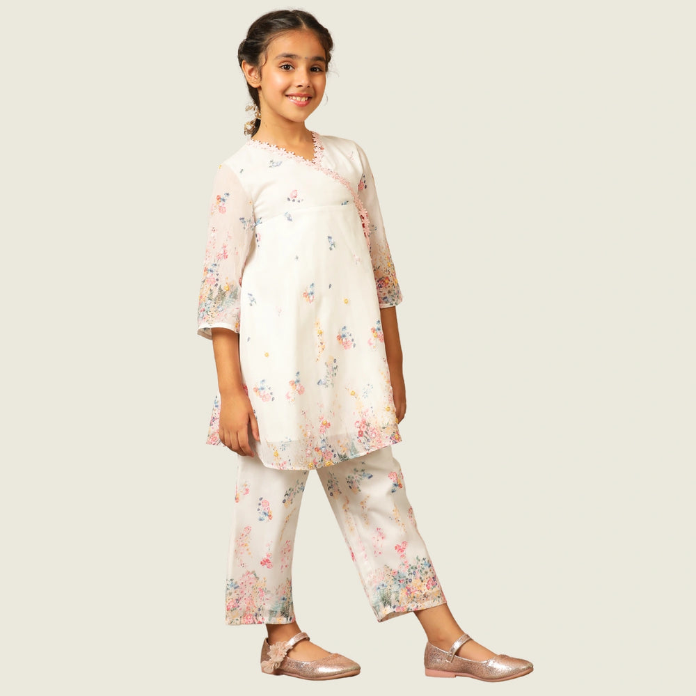 
                  
                     the Noor Kurti Set is a graceful ensemble perfect for dreamy celebrations. Set against a gentle white backdrop, the kurta features delicate multicolor floral prints scattered like wildflowers across the fabric. 
                  
                