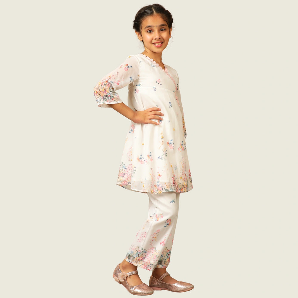 
                  
                     the Noor Kurti Set is a graceful ensemble perfect for dreamy celebrations. Set against a gentle white backdrop, the kurta features delicate multicolor floral prints scattered like wildflowers across the fabric. 
                  
                