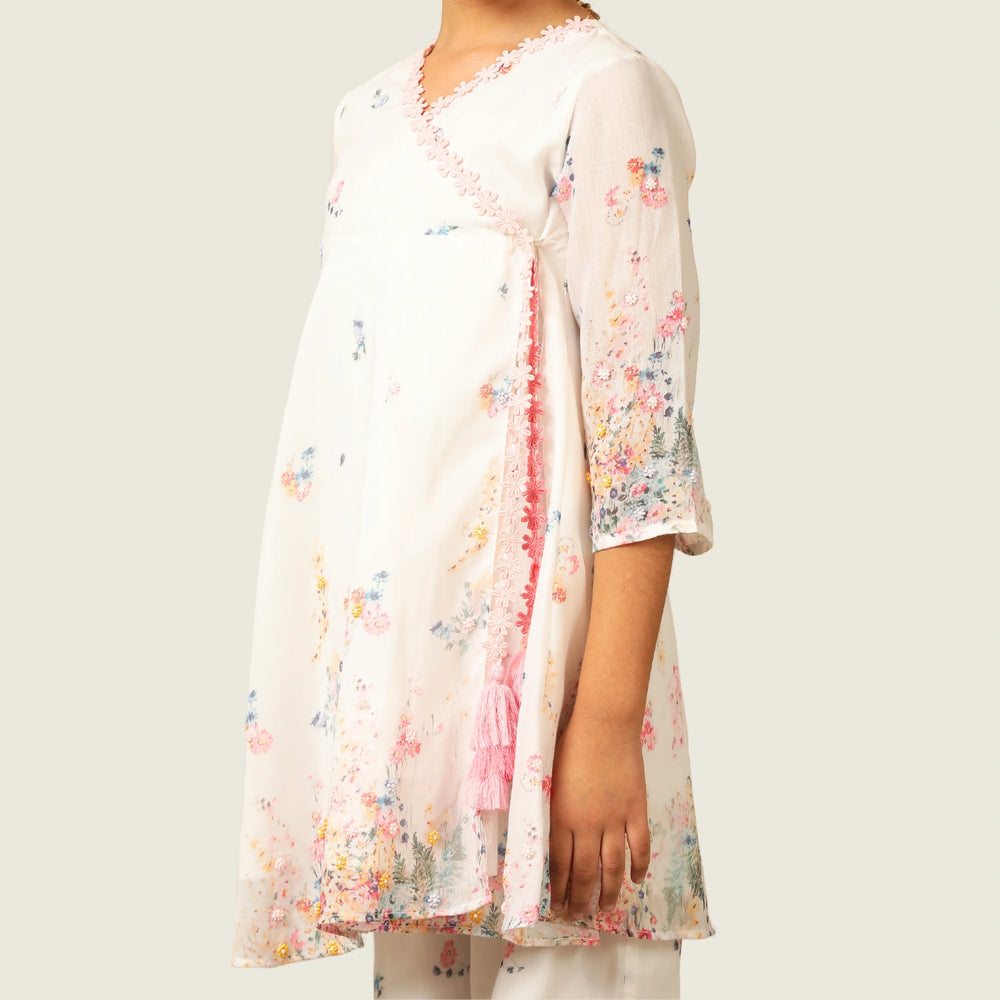 
                  
                     the Noor Kurti Set is a graceful ensemble perfect for dreamy celebrations. Set against a gentle white backdrop, the kurta features delicate multicolor floral prints scattered like wildflowers across the fabric. 
                  
                