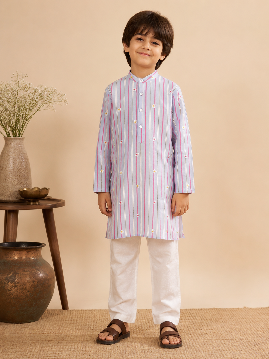 The Sunshine Flower Kurta Set brings a fresh take to traditional dressing. Crafted in a soft pastel stripe, the kurta features delicate floral embroidery that adds just the right touch of festivity without overwhelming the look. 