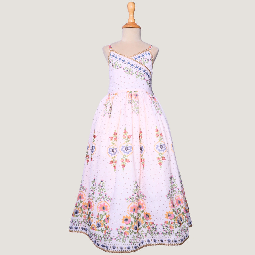 
                  
                     a graceful Indo-Western dress that blends tradition with whimsy. Crafted in soft, flowy Chanderi fabric, this dress features delicate floral prints, a flattering asymmetrical neckline, and dainty bead detailing along the straps and hem. 
                  
                
