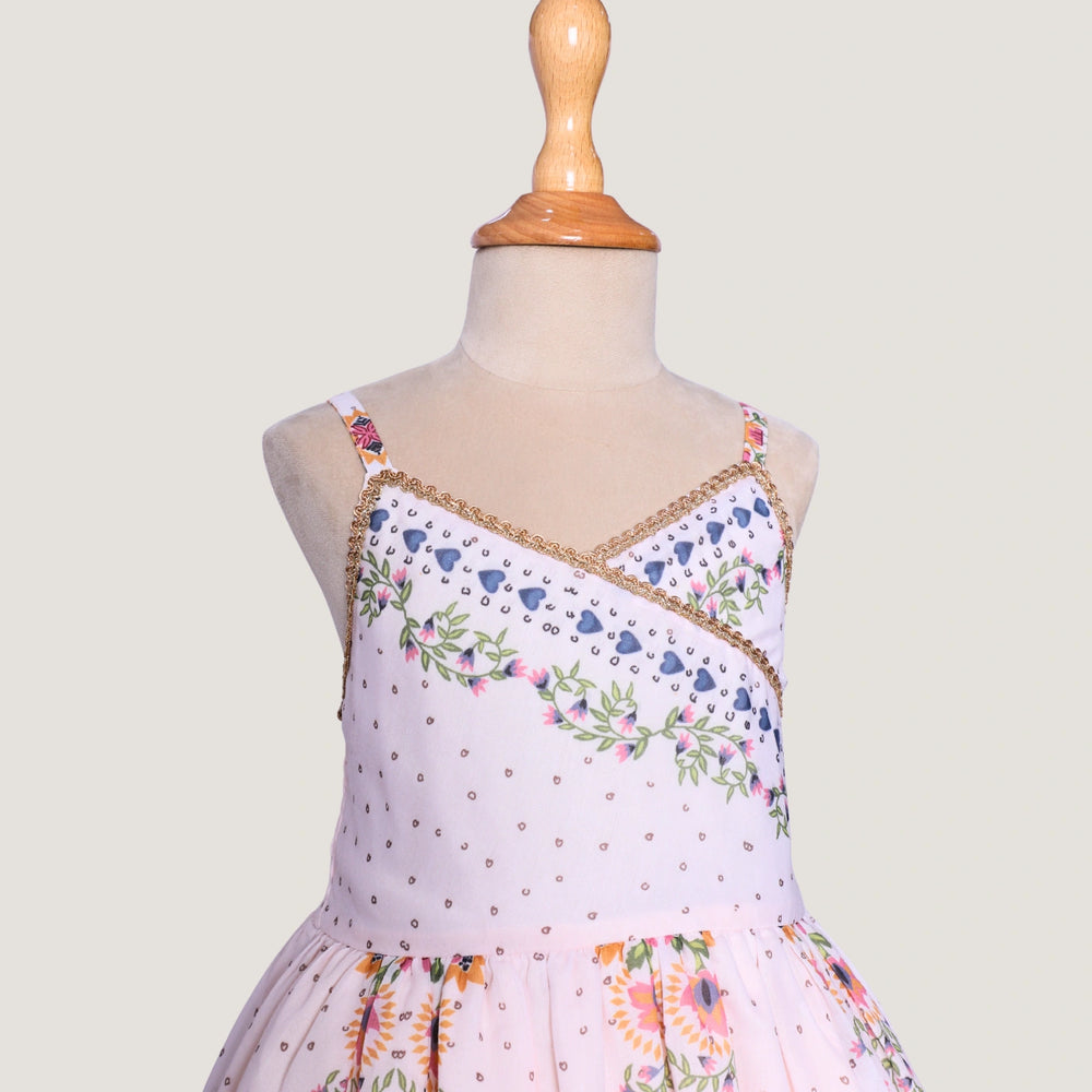
                  
                     a graceful Indo-Western dress that blends tradition with whimsy. Crafted in soft, flowy Chanderi fabric, this dress features delicate floral prints, a flattering asymmetrical neckline, and dainty bead detailing along the straps and hem. 
                  
                