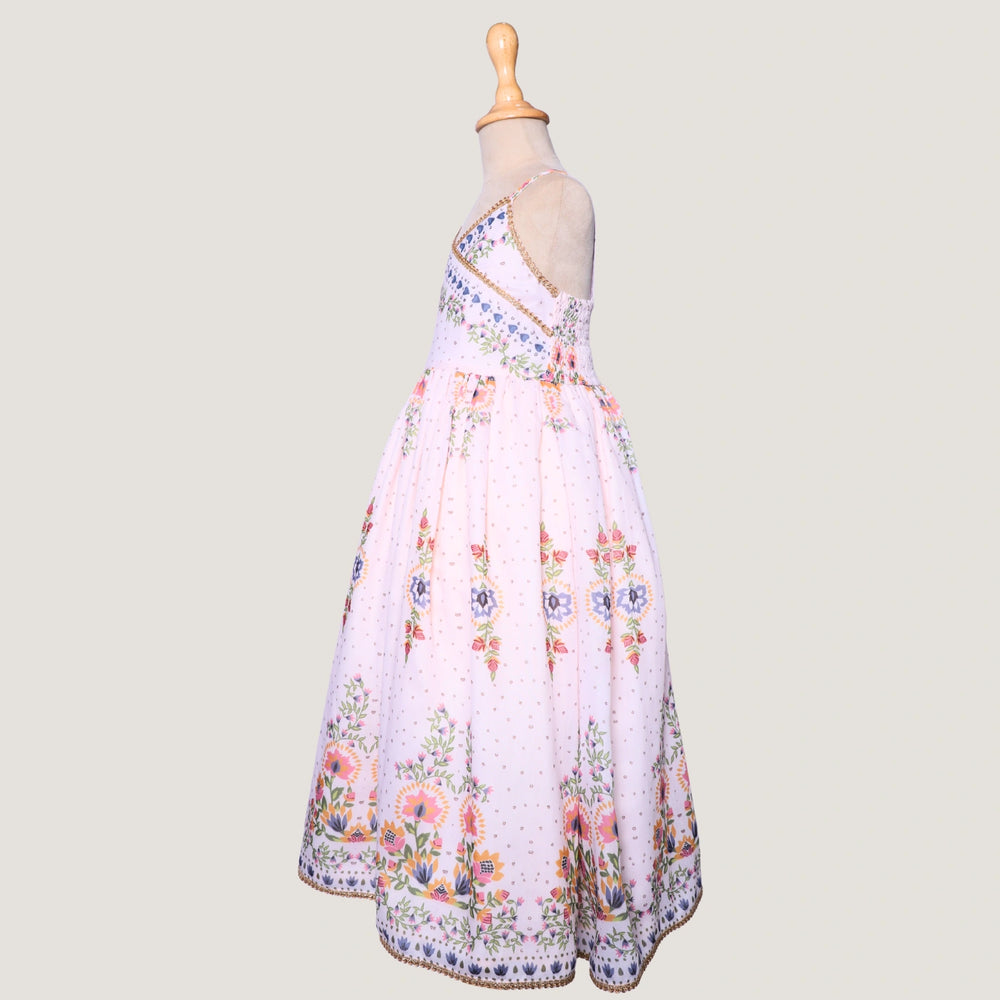 
                  
                     a graceful Indo-Western dress that blends tradition with whimsy. Crafted in soft, flowy Chanderi fabric, this dress features delicate floral prints, a flattering asymmetrical neckline, and dainty bead detailing along the straps and hem. 
                  
                