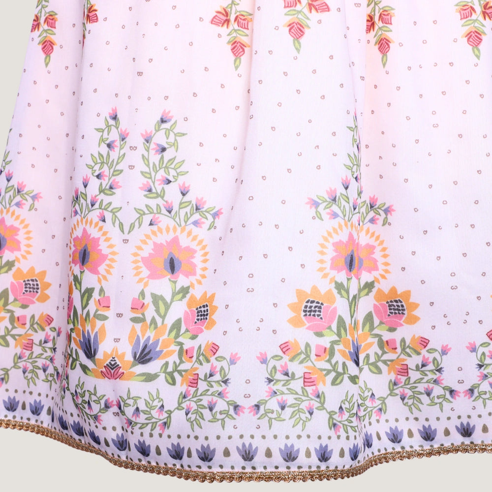 
                  
                     a graceful Indo-Western dress that blends tradition with whimsy. Crafted in soft, flowy Chanderi fabric, this dress features delicate floral prints, a flattering asymmetrical neckline, and dainty bead detailing along the straps and hem. 
                  
                