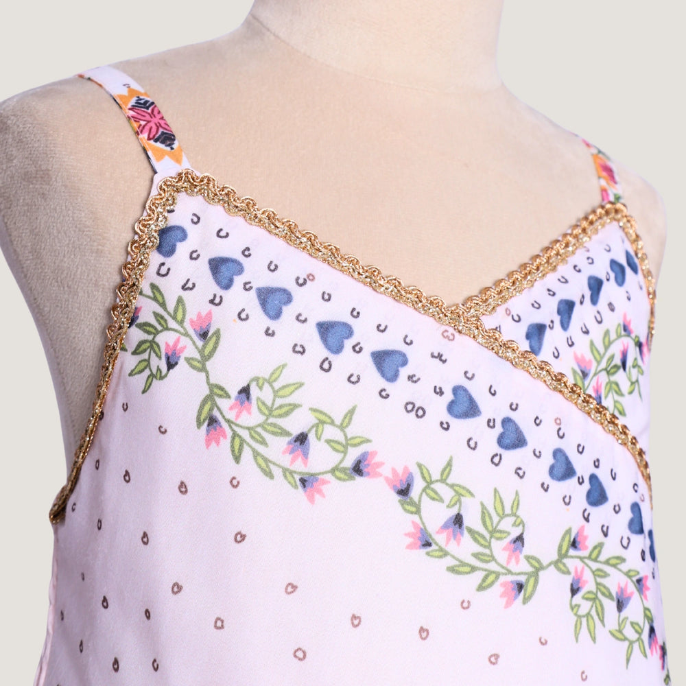 
                  
                     a graceful Indo-Western dress that blends tradition with whimsy. Crafted in soft, flowy Chanderi fabric, this dress features delicate floral prints, a flattering asymmetrical neckline, and dainty bead detailing along the straps and hem. 
                  
                