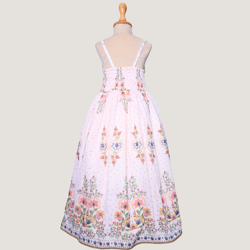 
                  
                     a graceful Indo-Western dress that blends tradition with whimsy. Crafted in soft, flowy Chanderi fabric, this dress features delicate floral prints, a flattering asymmetrical neckline, and dainty bead detailing along the straps and hem. 
                  
                