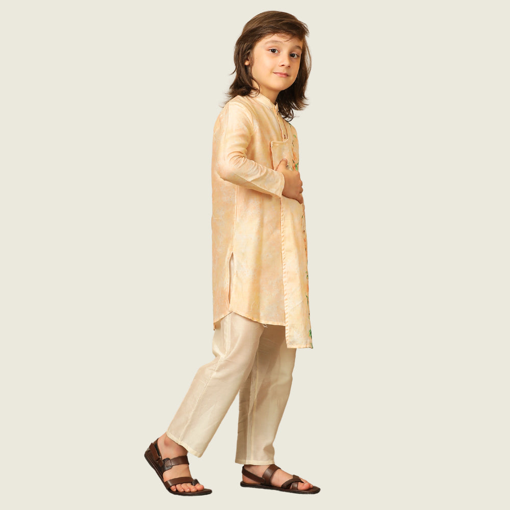 
                  
                    The Angrakha-style kurta for boys, features side tie detailing and a comfortable fit, paired with classic ivory pants for a clean, balanced look.
                  
                