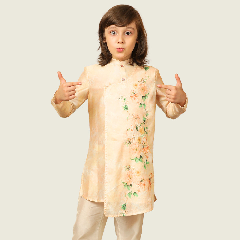 
                  
                    The Angrakha-style kurta for boys, features side tie detailing and a comfortable fit, paired with classic ivory pants for a clean, balanced look.
                  
                