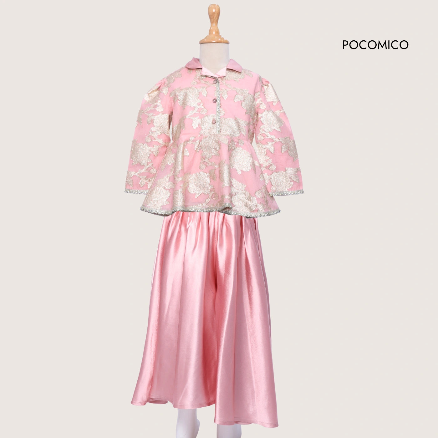 Pink floral coat and pink skirt set on a mannequin with 'Pocomico' branding.