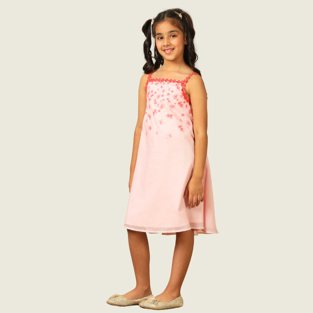 
                  
                    The Eira A-Line Dress is a playful ode to summer blooms. Crafted in a soft pink base, this sleeveless A-line dress features vibrant coral floral embroidery cascading from the neckline, with delicate flower appliqués adding texture and charm.
                  
                