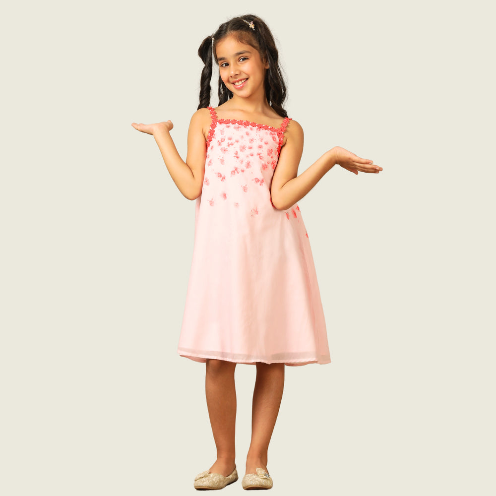 
                  
                    The Eira A-Line Dress is a playful ode to summer blooms. Crafted in a soft pink base, this sleeveless A-line dress features vibrant coral floral embroidery cascading from the neckline, with delicate flower appliqués adding texture and charm.
                  
                