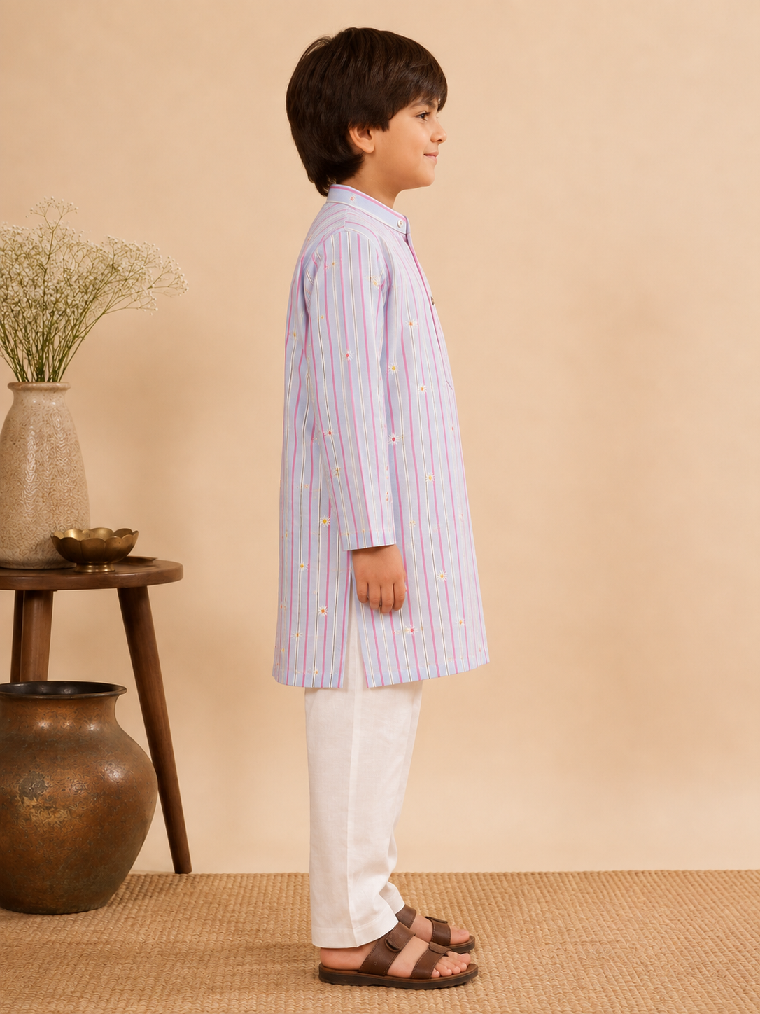 The Sunshine Flower Kurta Set brings a fresh take to traditional dressing. Crafted in a soft pastel stripe, the kurta features delicate floral embroidery that adds just the right touch of festivity without overwhelming the look. 