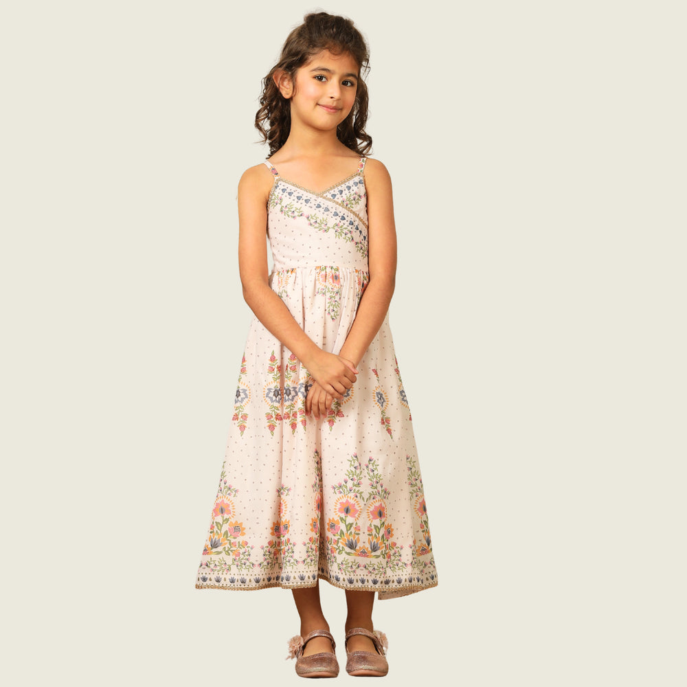 
                  
                     a graceful Indo-Western dress that blends tradition with whimsy. Crafted in soft, flowy Chanderi fabric, this dress features delicate floral prints, a flattering asymmetrical neckline, and dainty bead detailing along the straps and hem. 
                  
                