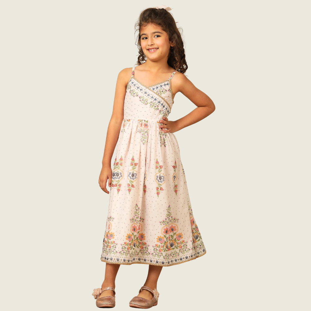 
                  
                     a graceful Indo-Western dress that blends tradition with whimsy. Crafted in soft, flowy Chanderi fabric, this dress features delicate floral prints, a flattering asymmetrical neckline, and dainty bead detailing along the straps and hem. 
                  
                
