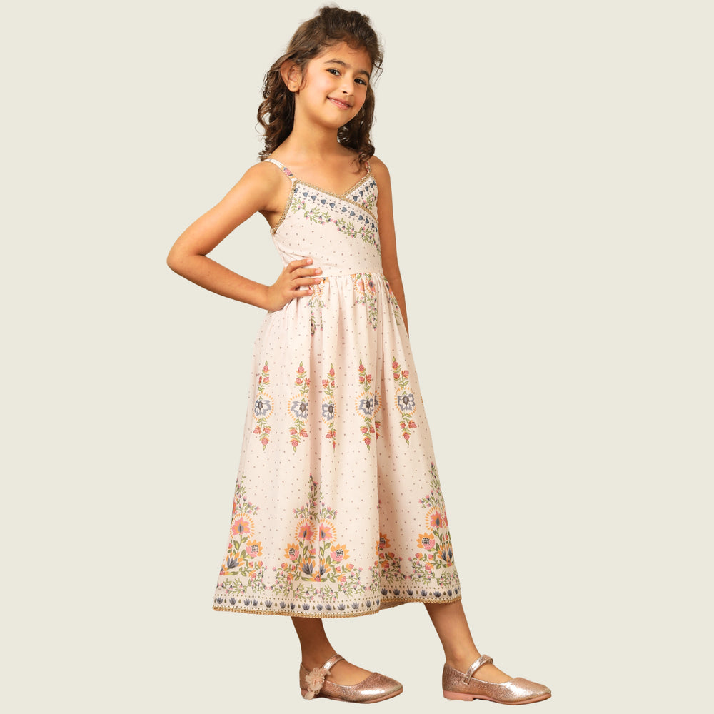 
                  
                     a graceful Indo-Western dress that blends tradition with whimsy. Crafted in soft, flowy Chanderi fabric, this dress features delicate floral prints, a flattering asymmetrical neckline, and dainty bead detailing along the straps and hem. 
                  
                