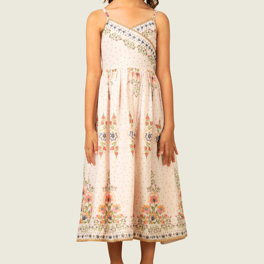 
                  
                     a graceful Indo-Western dress that blends tradition with whimsy. Crafted in soft, flowy Chanderi fabric, this dress features delicate floral prints, a flattering asymmetrical neckline, and dainty bead detailing along the straps and hem. 
                  
                