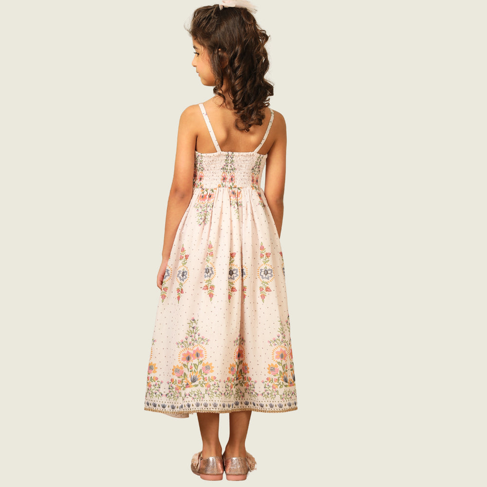 
                  
                     a graceful Indo-Western dress that blends tradition with whimsy. Crafted in soft, flowy Chanderi fabric, this dress features delicate floral prints, a flattering asymmetrical neckline, and dainty bead detailing along the straps and hem. 
                  
                