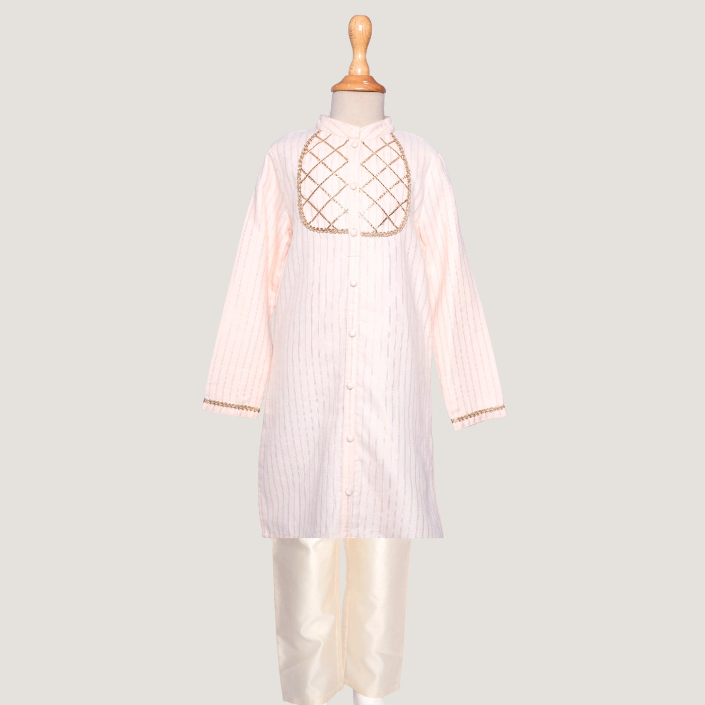 Elegant and timeless, this Rajni Gota kurta set for little boys is designed with delicate gota detailing that adds a festive sparkle. The kurta features a soft sheen and classic straight cut, paired with a comfortable churidaar for easy movement and all-day wear.