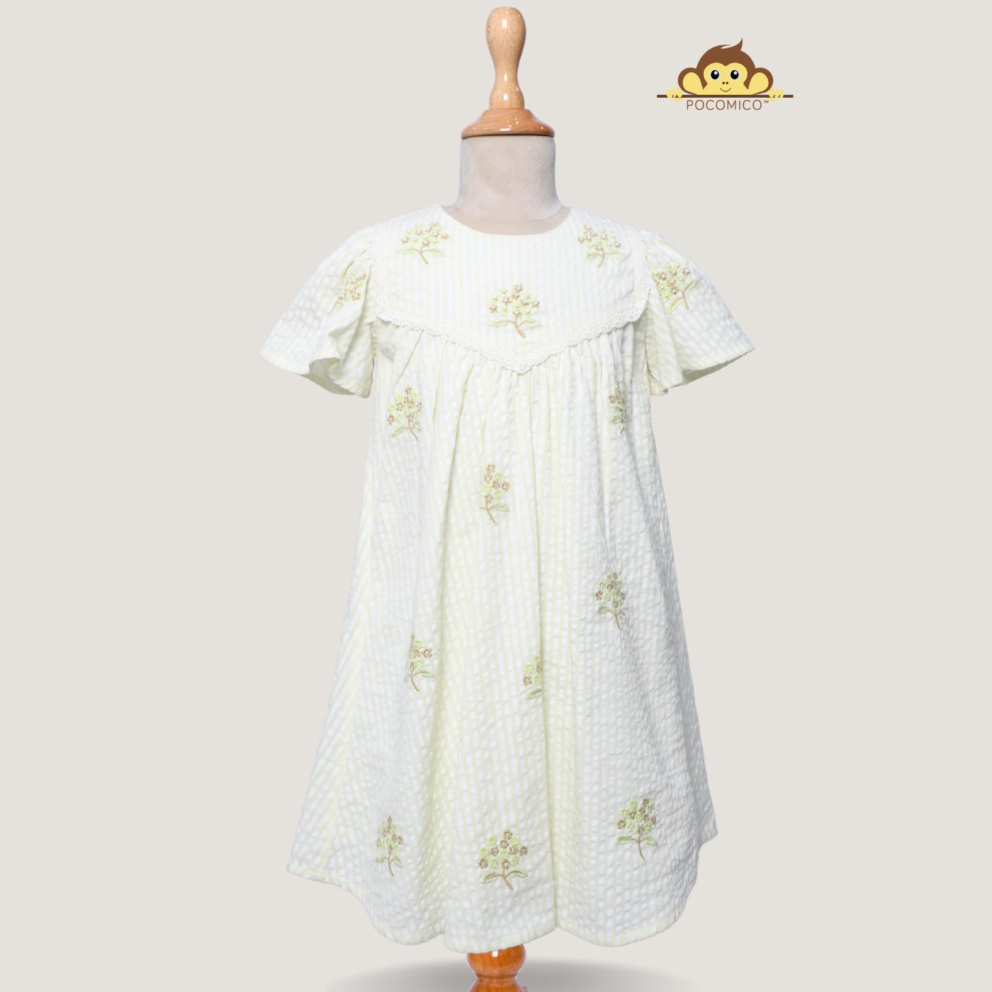 Breeze Embroidered Dress + POCOMICO + whimsical design + 100% BCI cotton + soft lime yellow fabric + delicate embroidery + girls adventure outfit + versatile layering piece + perfect for exploring and expressing creativity + stylish and comfortable + floral + embroidery + flower + seersucker fabric