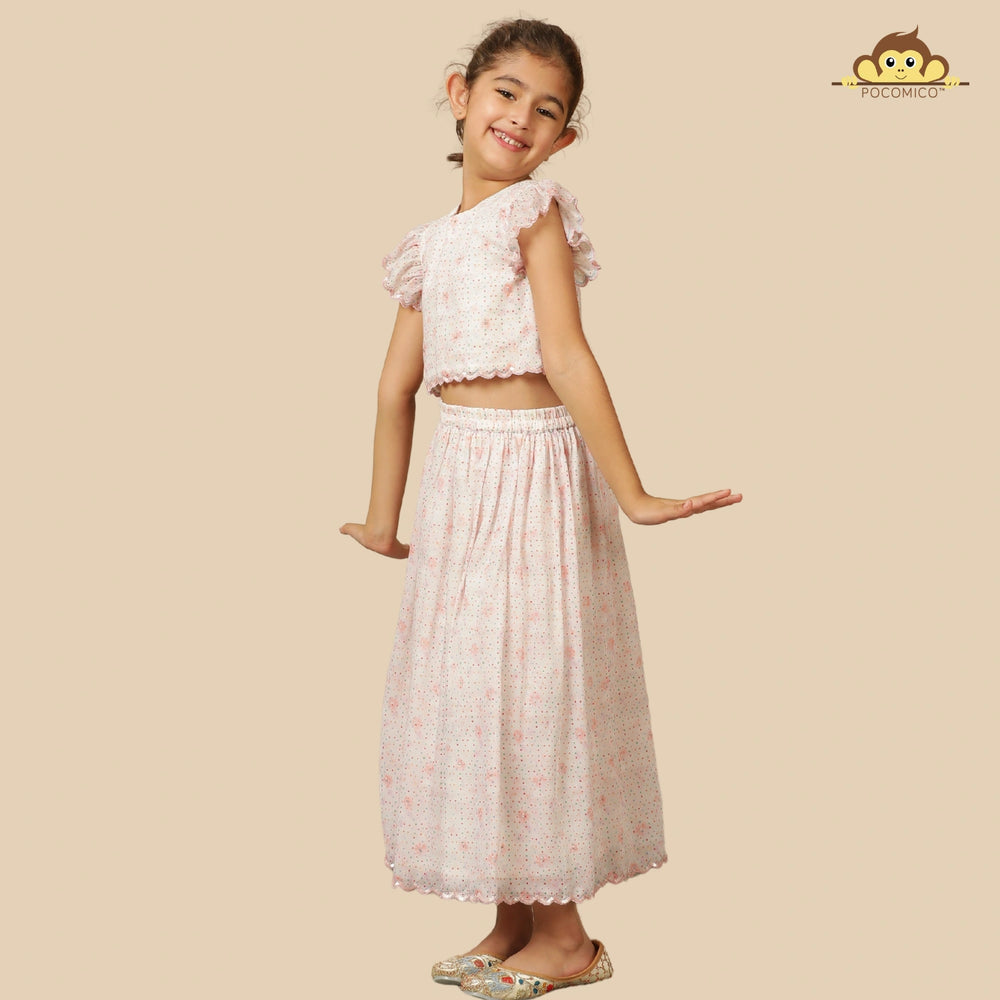 
                  
                    The Aabha Lehenga Dress Set is a sweet and sparkly outfit made for magical moments. Crafted in a soft pastel pink base, this dress is adorned with delicate floral prints and shimmering polka dots all over. 
                  
                