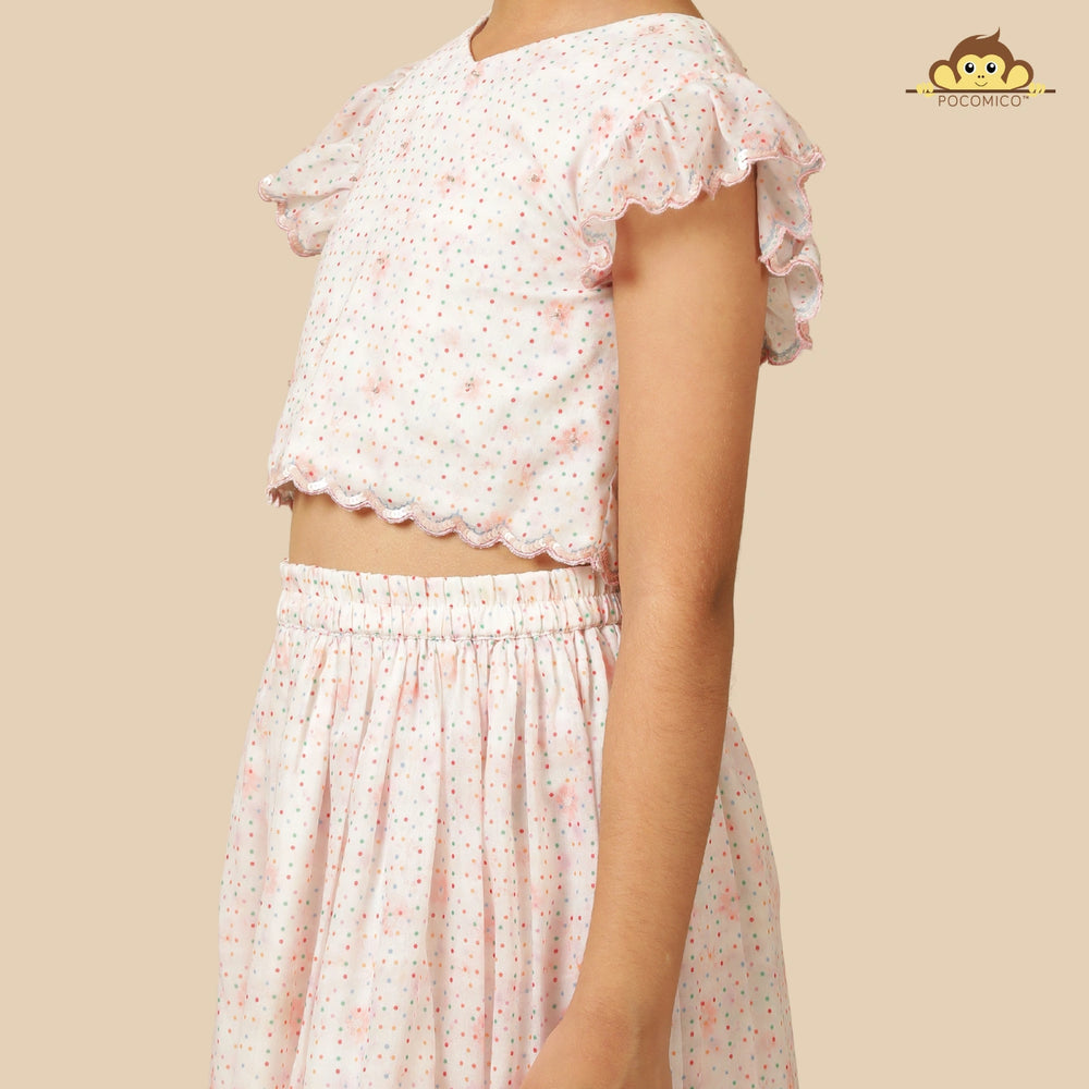 
                  
                    The Aabha Lehenga Dress Set is a sweet and sparkly outfit made for magical moments. Crafted in a soft pastel pink base, this dress is adorned with delicate floral prints and shimmering polka dots all over. 
                  
                