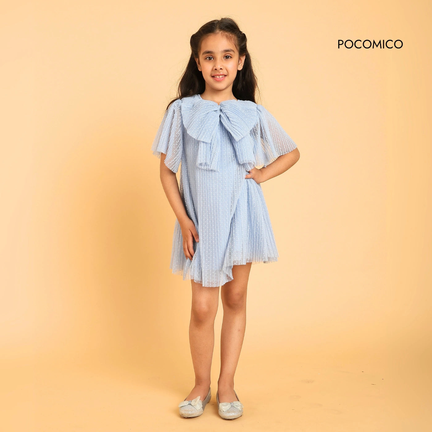  Bow Belle Mesh Dress is straight out of a storybook. Crafted with a soft mesh overlay, pleated fabric, ruffes, bows and 100% BCI cotton lining, it’s light, airy, and made for twirls! 