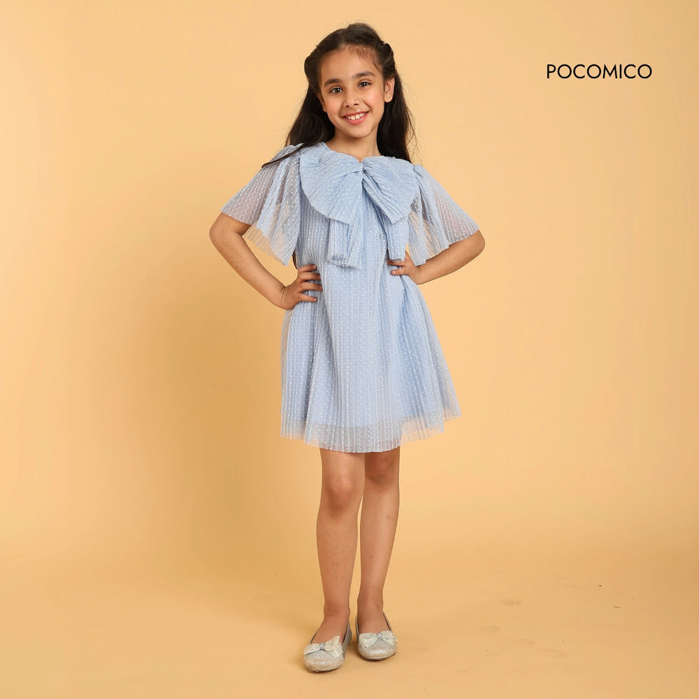  Bow Belle Mesh Dress is straight out of a storybook. Crafted with a soft mesh overlay, pleated fabric, ruffes, bows and 100% BCI cotton lining, it’s light, airy, and made for twirls! 