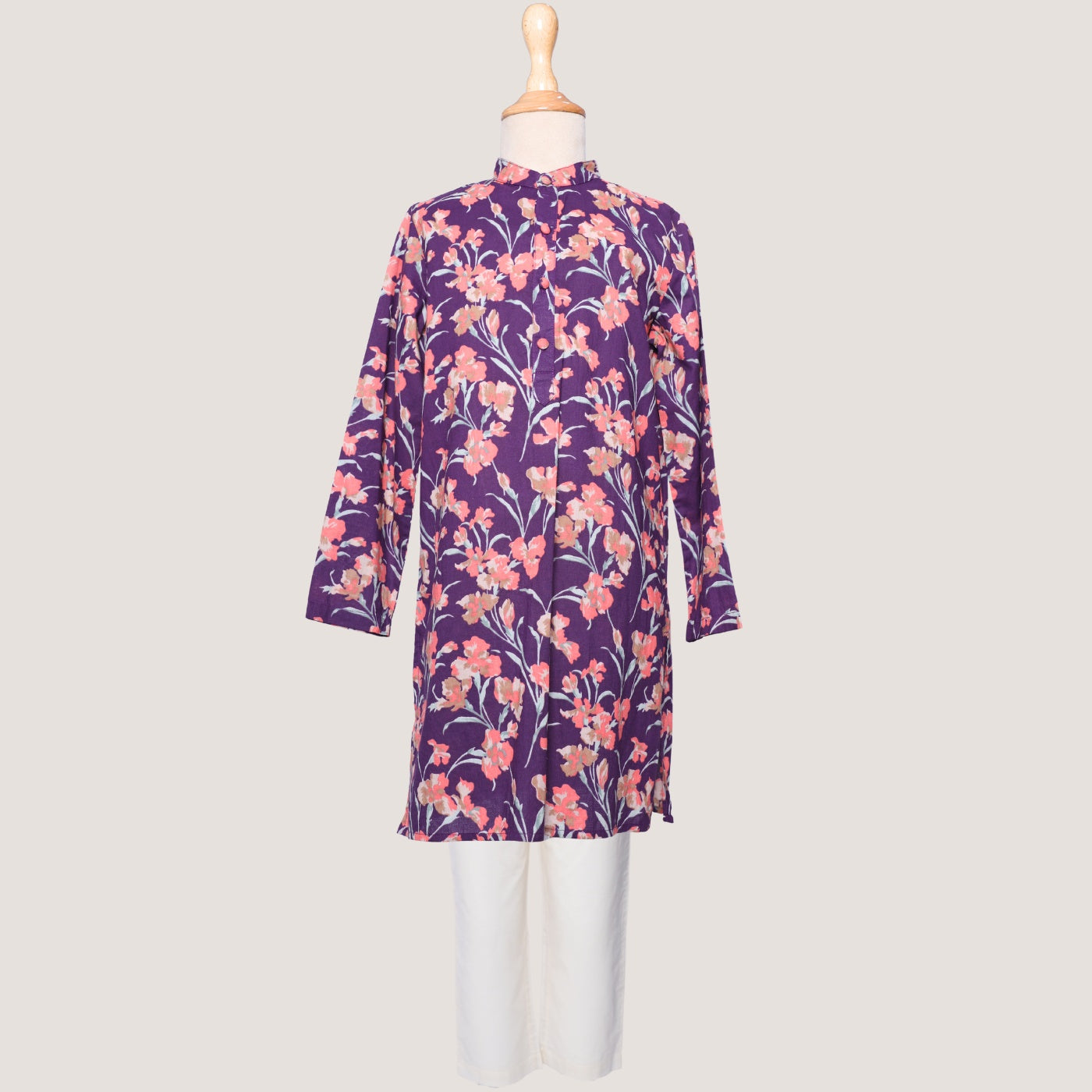 A kurta set for little boys, featuring a long-sleeved purple shirt with a floral print and white trousers.