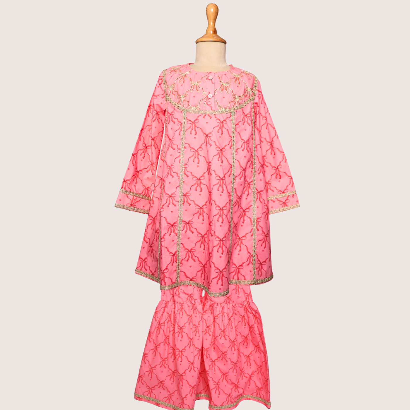 Elegant with a touch of festive shine, the Rosette Poplin Sharara Set is crafted in lightweight poplin fabric, offering a soft sheen while remaining breathable.