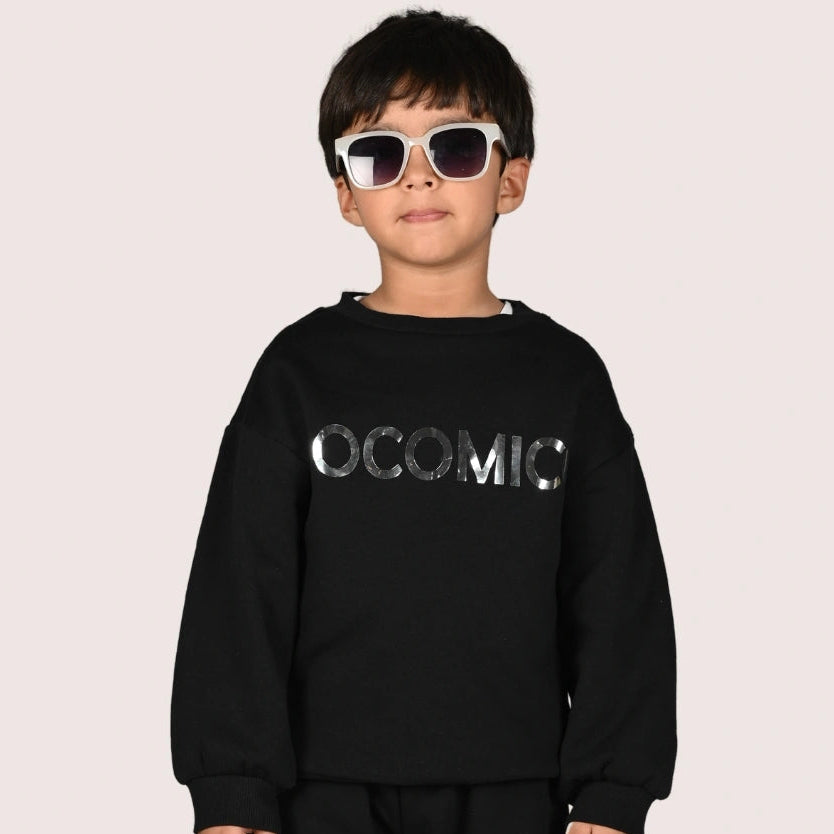 Child wearing a black outfit with 'POCOMICO' text on a plain background