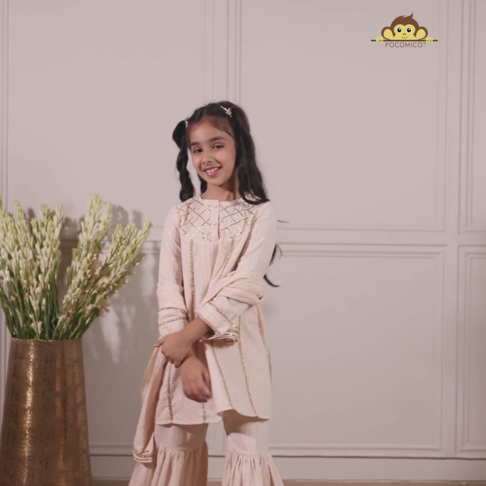 
                  
                    Load and play video in Gallery viewer, Elegant in its simplicity, the Rajni Sharara Set is a refined ensemble for special occasions. Crafted in a soft ivory-peach hue with subtle&amp;nbsp;pinstripes, this set features a straight-cut kurta with delicate gold threadwork detailing on the yoke and sleeves. 
                  
                