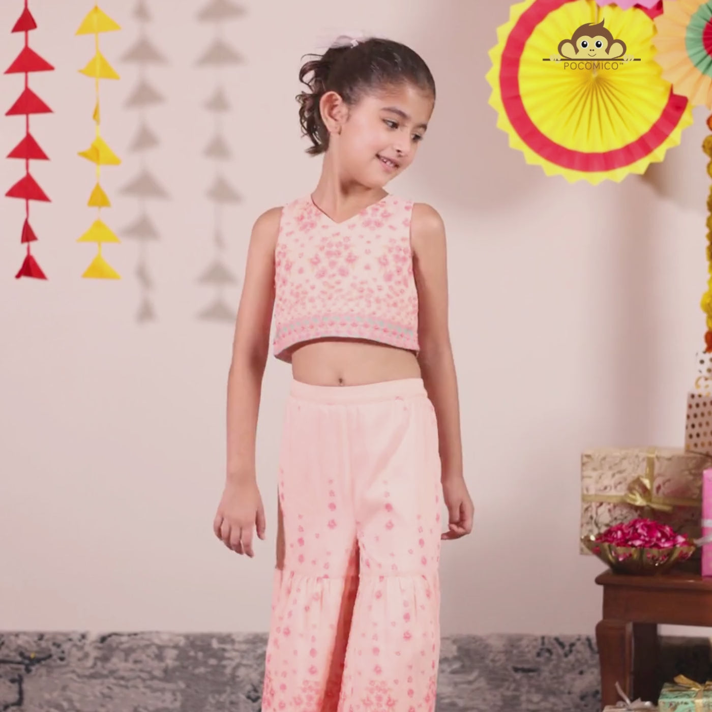 The Meher Sharara Set is a fresh and festive outfit designed for twirls and celebrations. Featuring a sleeveless crop top with a V-neckline and delicate floral embroidery, it’s paired with matching tiered sharara pants
