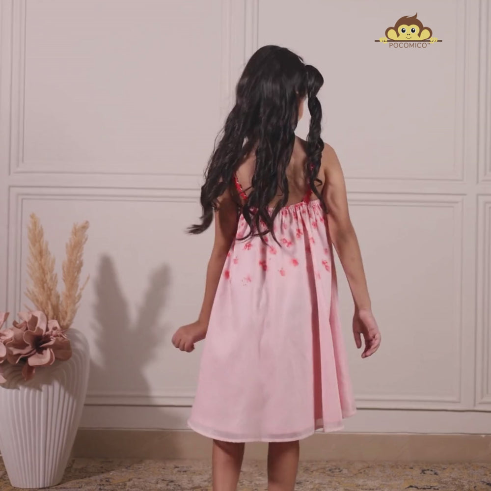 
                  
                    Load and play video in Gallery viewer, The Eira A-Line Dress is a playful ode to summer blooms. Crafted in a soft pink base, this sleeveless A-line dress features vibrant coral floral embroidery cascading from the neckline, with delicate flower appliqués adding texture and charm.
                  
                