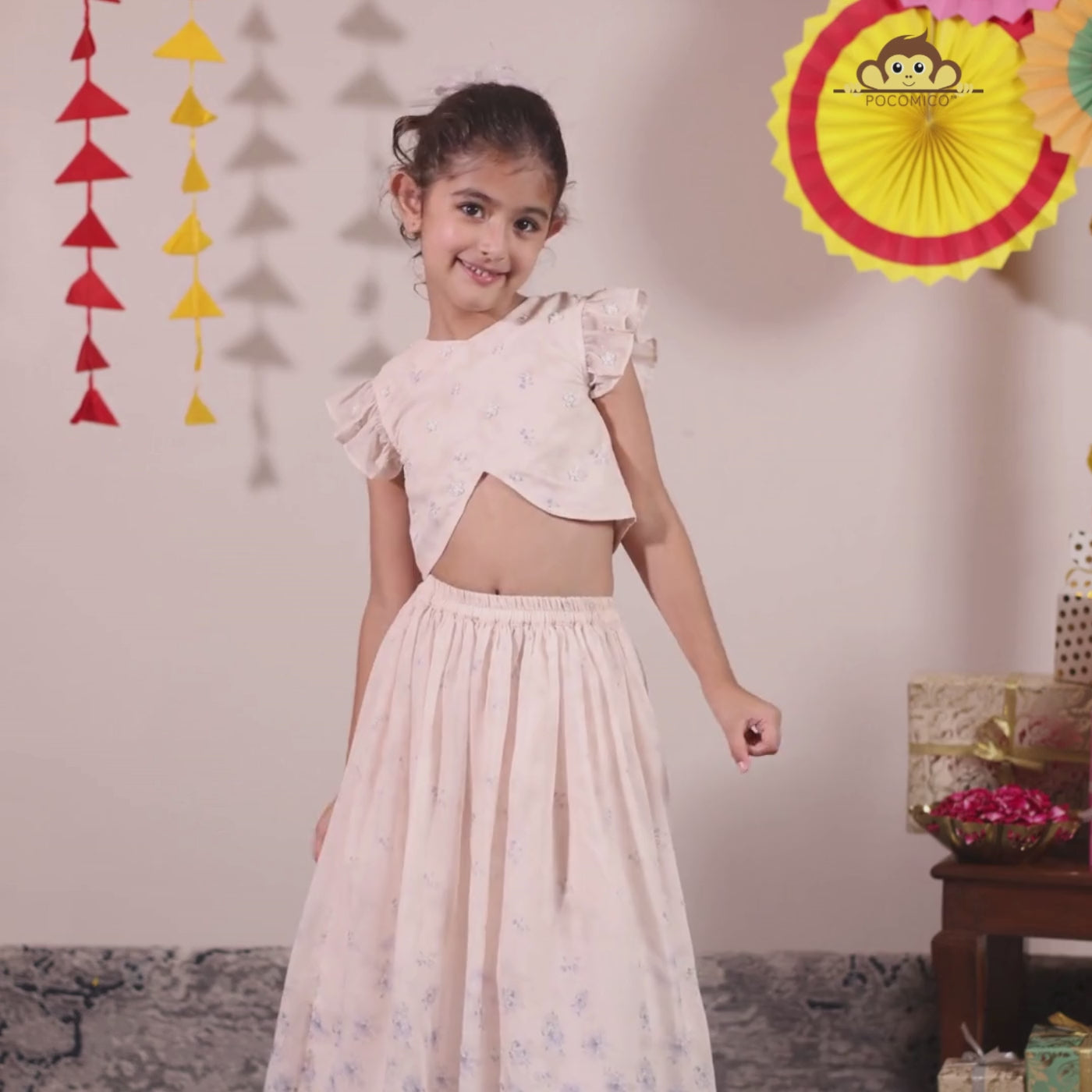 The Aabha Lehenga Dress Set is a sweet and sparkly outfit made for magical moments. Crafted in a soft pastel pink base, this dress is adorned with delicate floral prints and shimmering polka dots all over. 