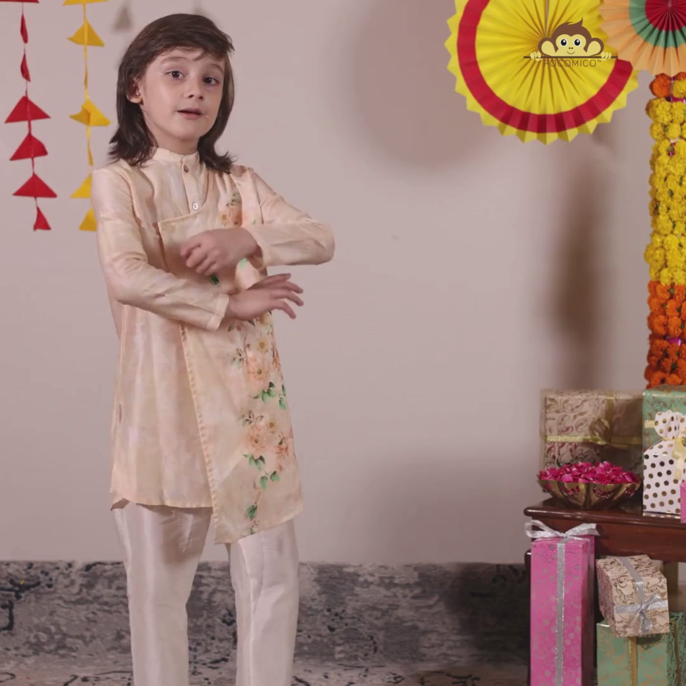 The Angrakha-style kurta for boys, features side tie detailing and a comfortable fit, paired with classic ivory pants for a clean, balanced look.