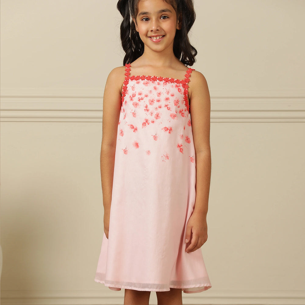 
                  
                    The Eira A-Line Dress is a playful ode to summer blooms. Crafted in a soft pink base, this sleeveless A-line dress features vibrant coral floral embroidery cascading from the neckline, with delicate flower appliqués adding texture and charm.
                  
                