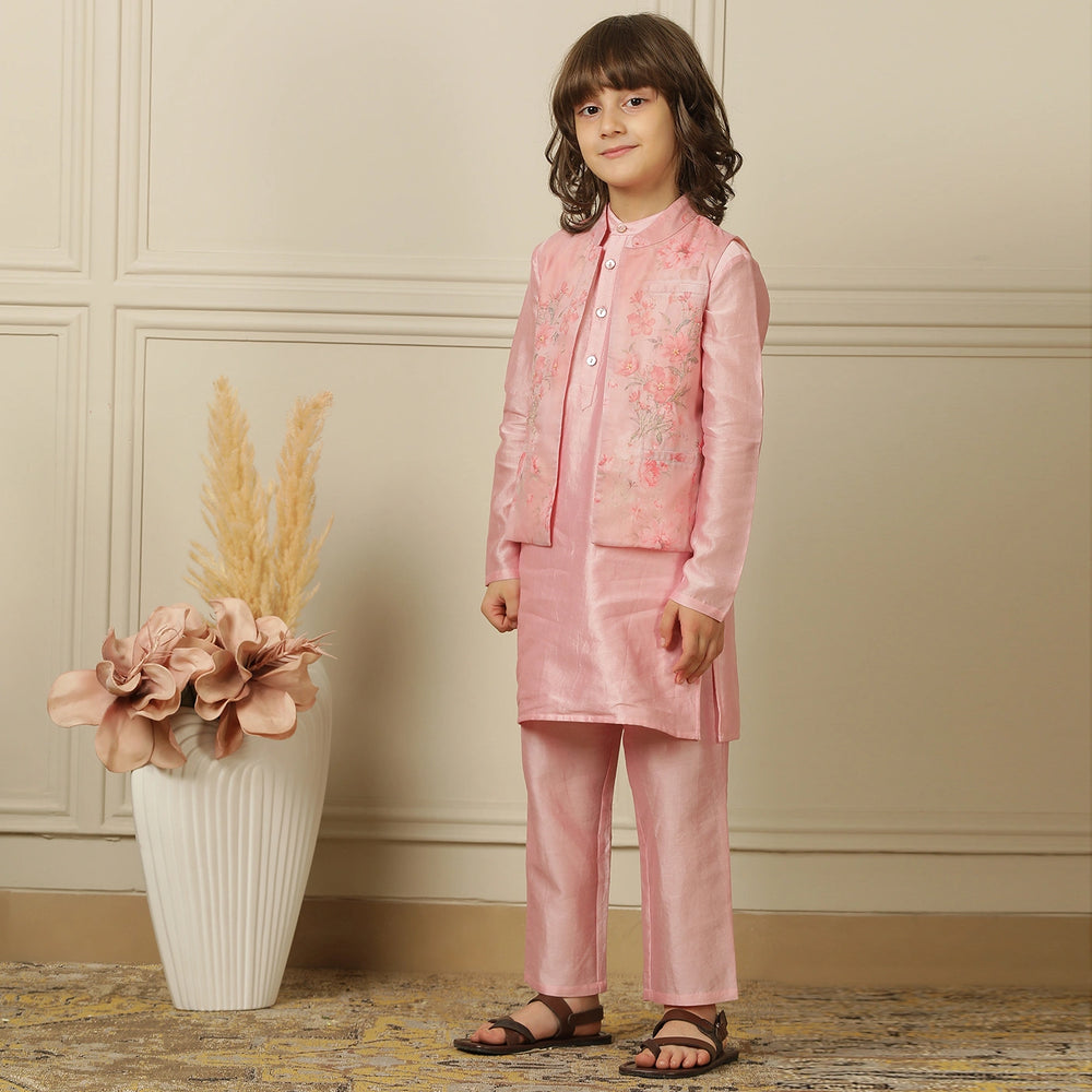 The Gulbahaar set is a graceful ode to festive tradition, featuring a pastel pink chanderi kurta paired with straight pants and a finely embroidered Nehru jacket blooming with soft floral design. 