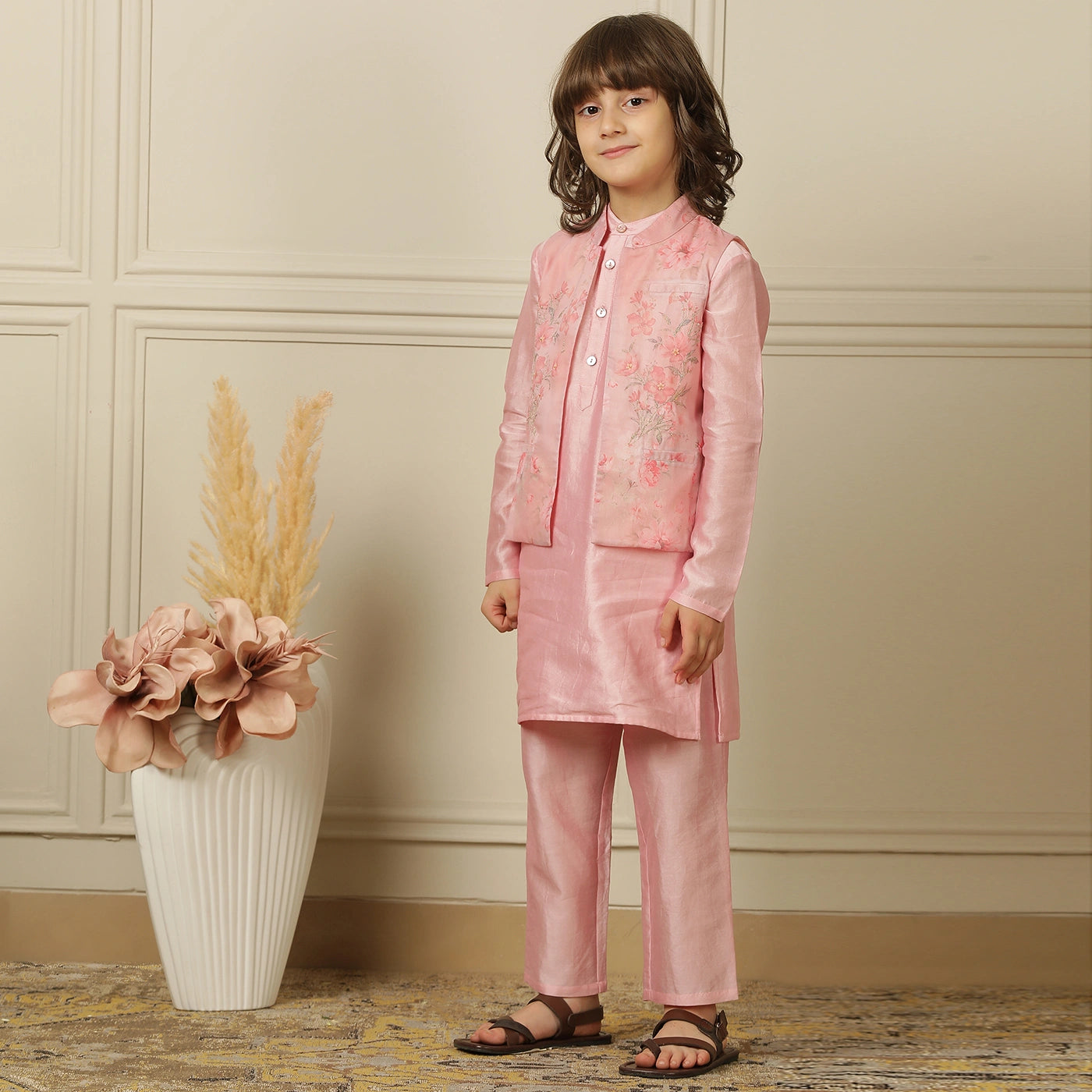 The Gulbahaar set is a graceful ode to festive tradition, featuring a pastel pink chanderi kurta paired with straight pants and a finely embroidered Nehru jacket blooming with soft floral design. 