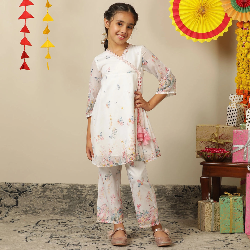 
                  
                     the Noor Kurti Set is a graceful ensemble perfect for dreamy celebrations. Set against a gentle white backdrop, the kurta features delicate multicolor floral prints scattered like wildflowers across the fabric. 
                  
                