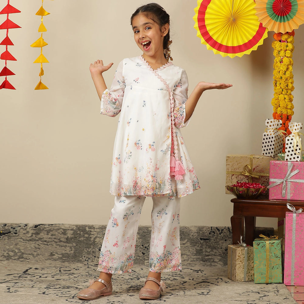 
                  
                     the Noor Kurti Set is a graceful ensemble perfect for dreamy celebrations. Set against a gentle white backdrop, the kurta features delicate multicolor floral prints scattered like wildflowers across the fabric. 
                  
                