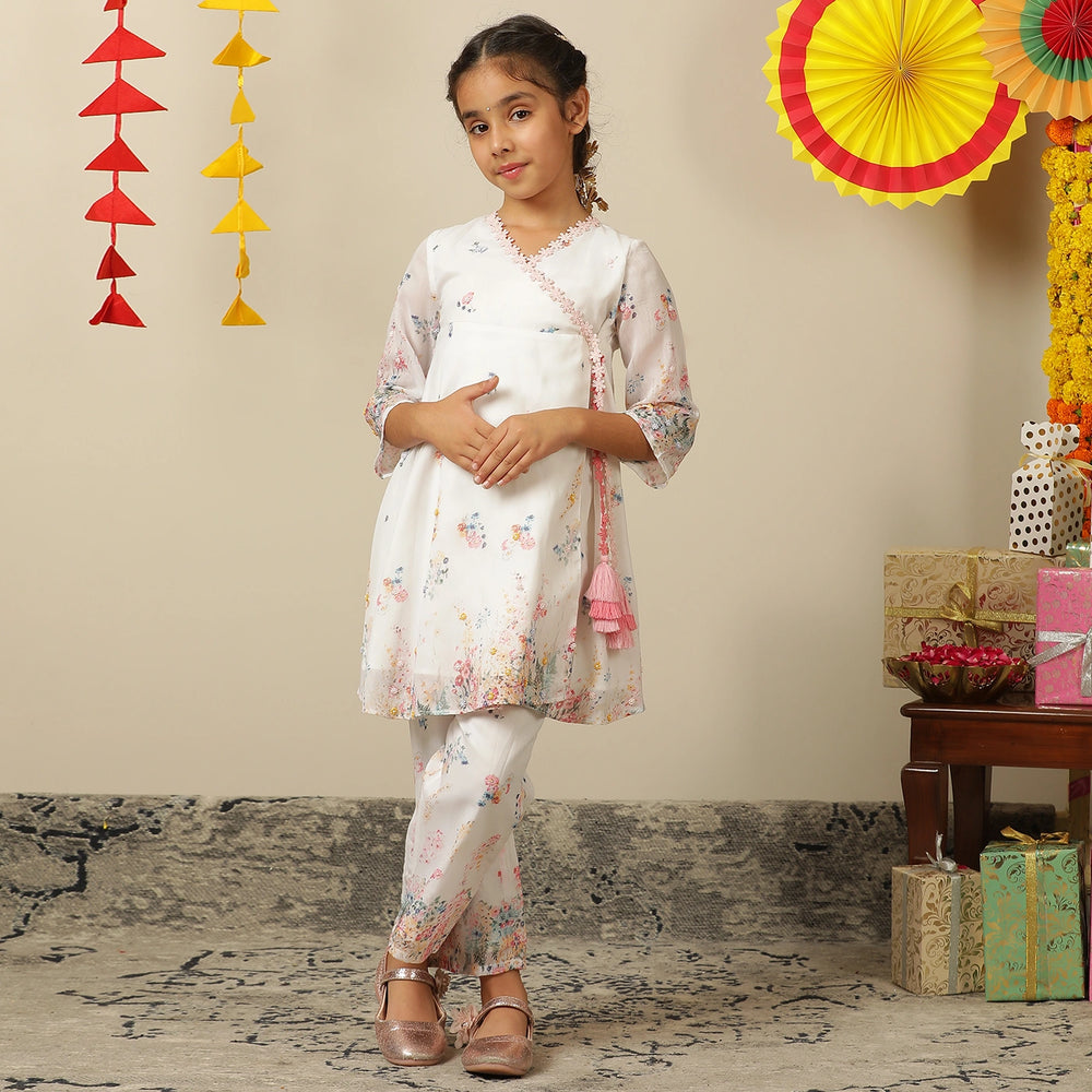 
                  
                     the Noor Kurti Set is a graceful ensemble perfect for dreamy celebrations. Set against a gentle white backdrop, the kurta features delicate multicolor floral prints scattered like wildflowers across the fabric. 
                  
                