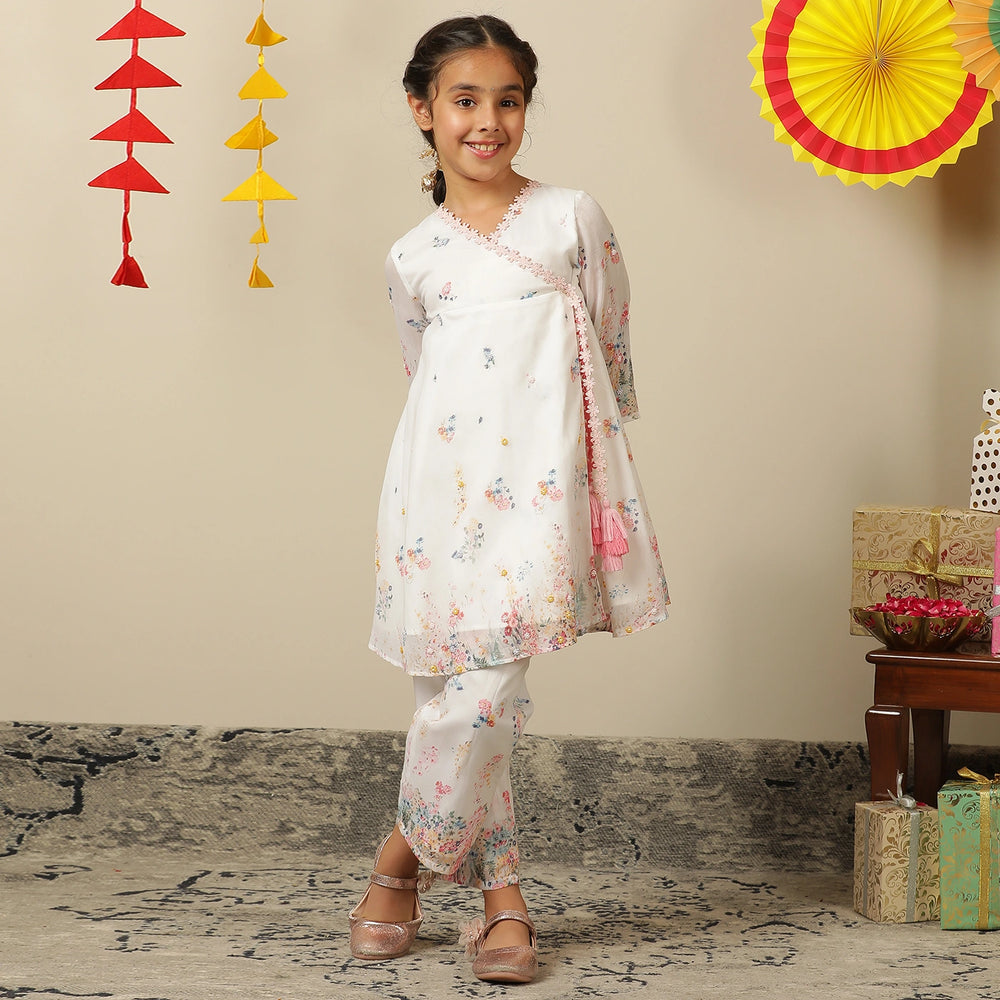 
                  
                     the Noor Kurti Set is a graceful ensemble perfect for dreamy celebrations. Set against a gentle white backdrop, the kurta features delicate multicolor floral prints scattered like wildflowers across the fabric. 
                  
                