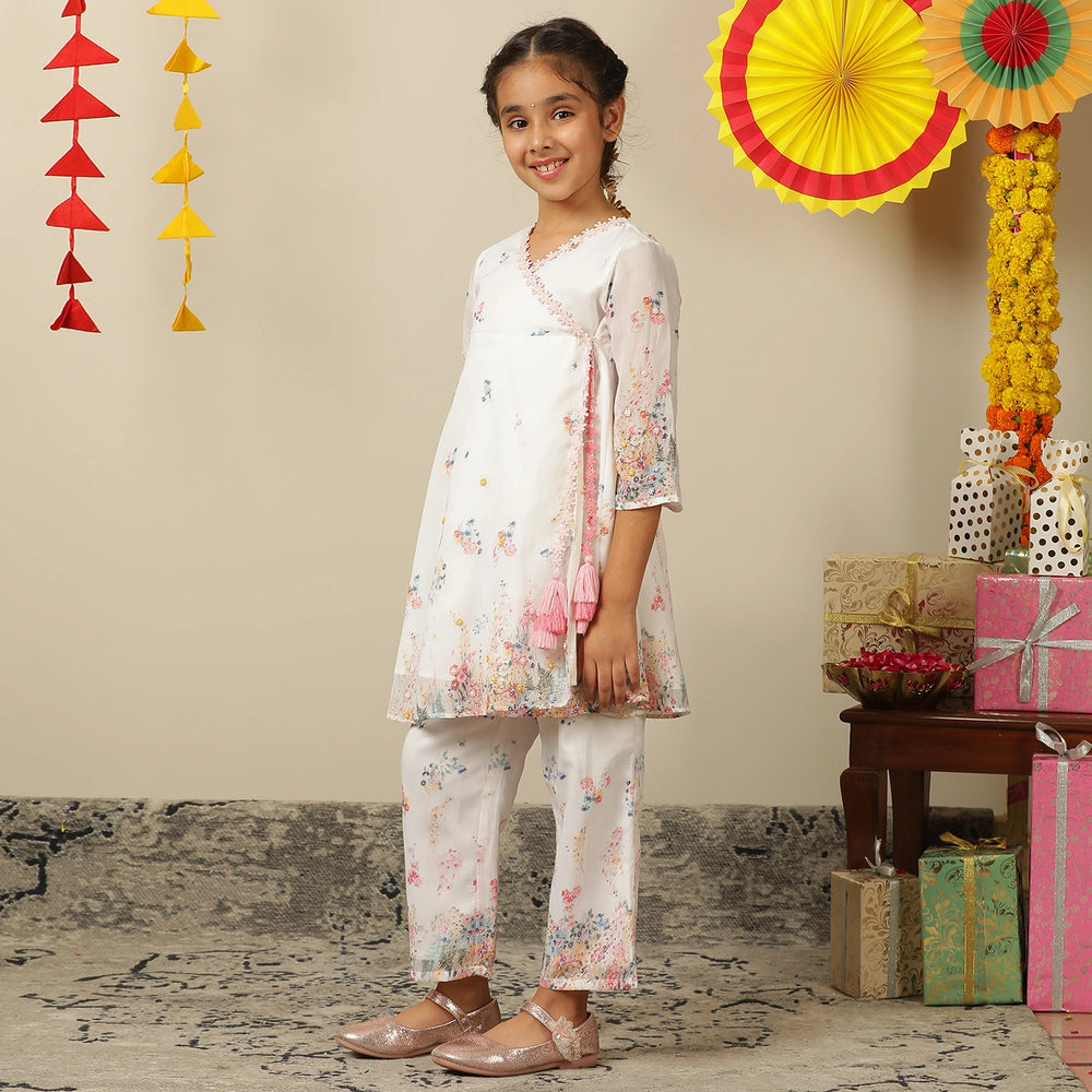 
                  
                     the Noor Kurti Set is a graceful ensemble perfect for dreamy celebrations. Set against a gentle white backdrop, the kurta features delicate multicolor floral prints scattered like wildflowers across the fabric. 
                  
                